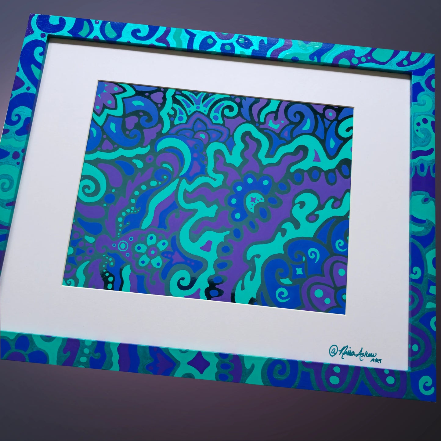 Electric Bloom by Nissa Askew - A framed abstract art print featuring a vibrant psychedelic swirl pattern in shades of teal, turquoise, purple, and blue, set within a wide white mat and a matching patterned frame.