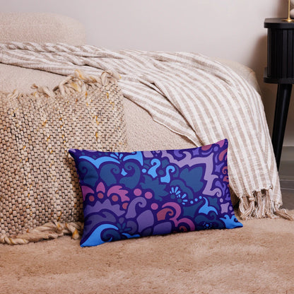 Midnight Berry throw pillow featuring deep, rich colors and elegant, swirly floral-like patterns, resting next to a living room couch.