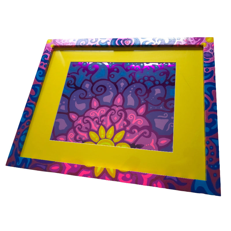 A square decorative picture frame with a bright yellow mat and a colorful psychedelic border, holding a matching mandala art print on a white background.