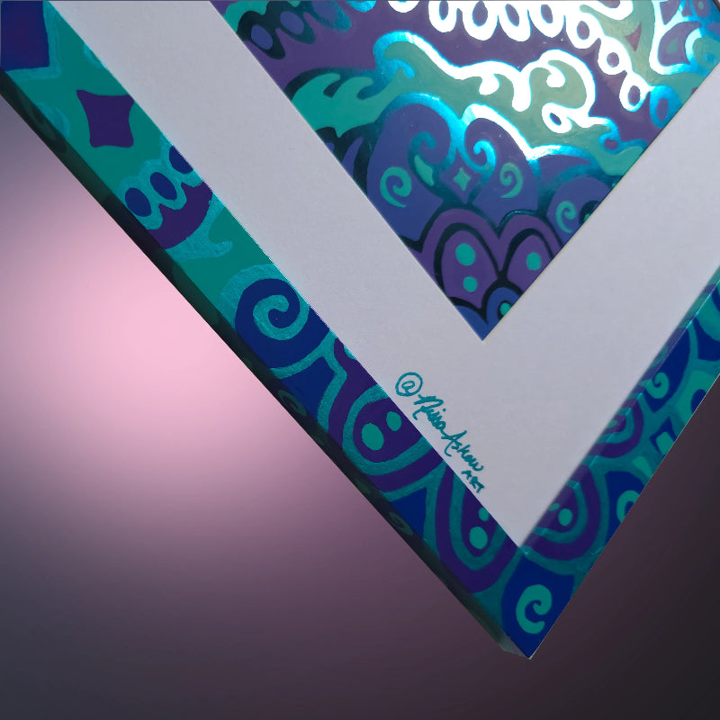 A close-up of a square art print or canvas showing a colorful abstract pattern with swirling teal, blue, purple, and white shapes. The print is photographed at an angle against a soft pink-to-purple gradient background, with a small artist signature visible along the white corner edge.