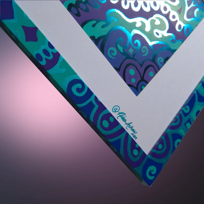A close-up of a square art print or canvas showing a colorful abstract pattern with swirling teal, blue, purple, and white shapes. The print is photographed at an angle against a soft pink-to-purple gradient background, with a small artist signature visible along the white corner edge.