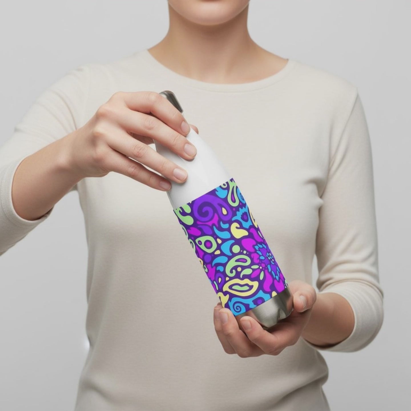 Person holding and turning the view of a Cyber Bloom stainless steel water bottle